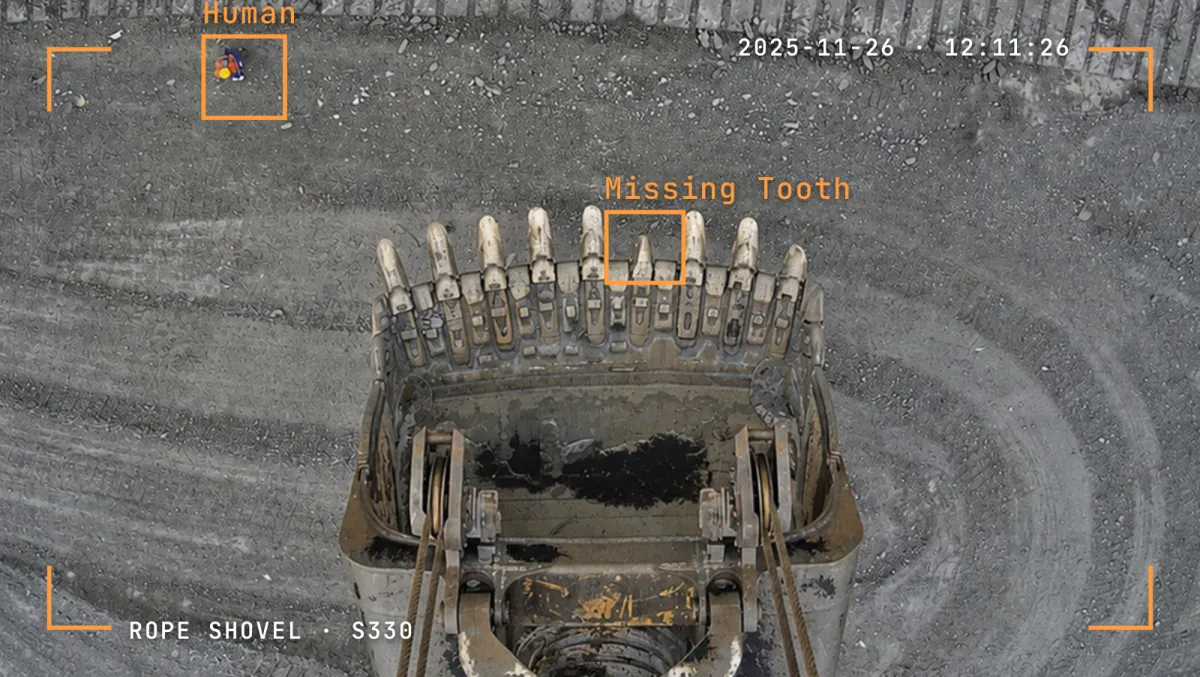 Overhead rope shovel camera view with a missing bucket tooth flagged.